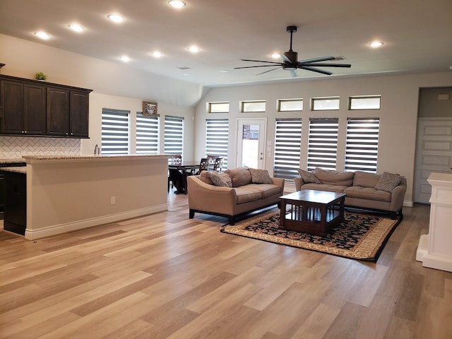 living room featuring recessed lighting, baseboards, a ceiling fan, and light wood-type flooring
