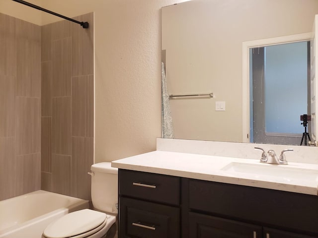 full bath with vanity, a textured wall, tub / shower combination, and toilet