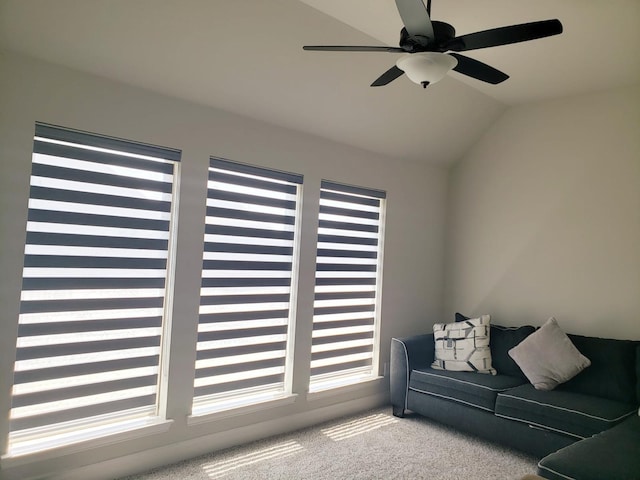 living area featuring carpet, a ceiling fan, and lofted ceiling