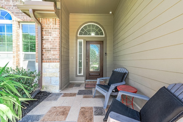 view of exterior entry with brick siding