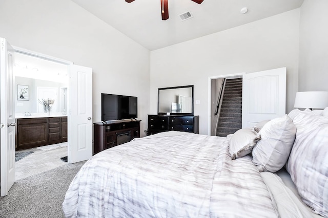bedroom featuring visible vents, ceiling fan, ensuite bath, and high vaulted ceiling