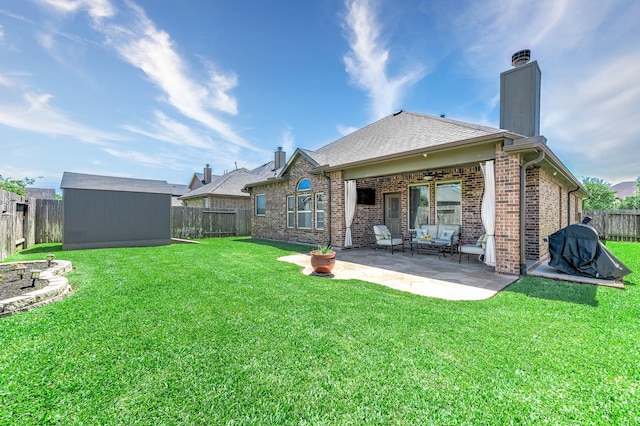 back of property with brick siding, ceiling fan, a shed, a fenced backyard, and a chimney