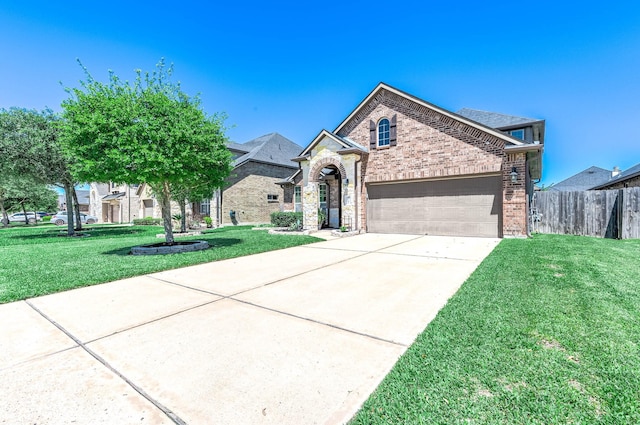 french country home with a garage, a front lawn, fence, brick siding, and concrete driveway