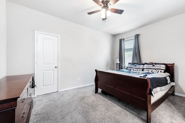carpeted bedroom with a ceiling fan and baseboards