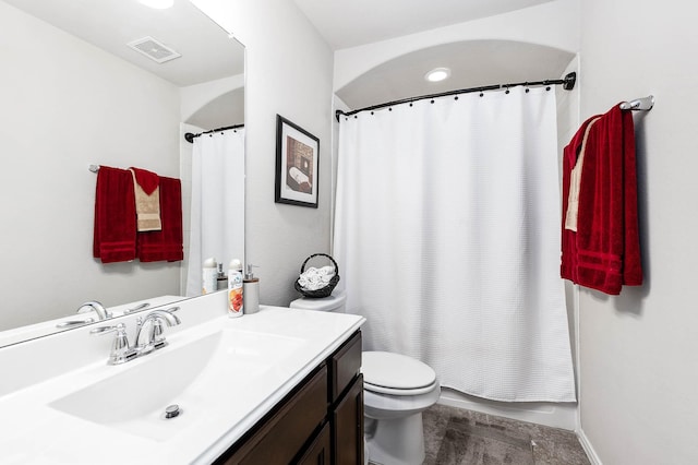bathroom with toilet, visible vents, and vanity