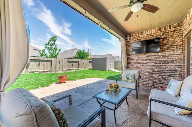 view of patio featuring an outdoor hangout area, a shed, a fenced backyard, a ceiling fan, and an outdoor structure