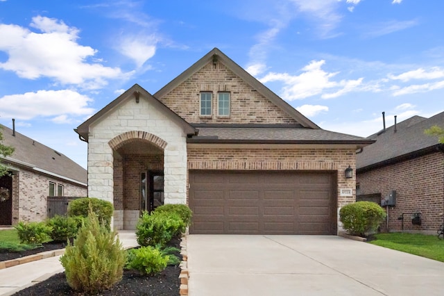 10723 Bridgeport Path Ct, Missouri City, TX 77459 - view of front of home with a shingled roof, stone siding, driveway, and brick siding