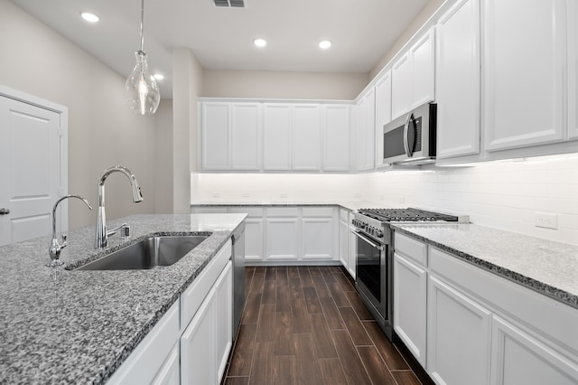 10723 Bridgeport Path Ct, Missouri City, TX 77459 - kitchen featuring white cabinets, stainless steel appliances, light stone counters, and a sink