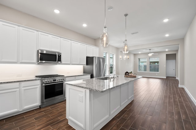 10723 Bridgeport Path Ct, Missouri City, TX 77459 - kitchen with appliances with stainless steel finishes, tasteful backsplash, dark wood finished floors, a sink, and white cabinets