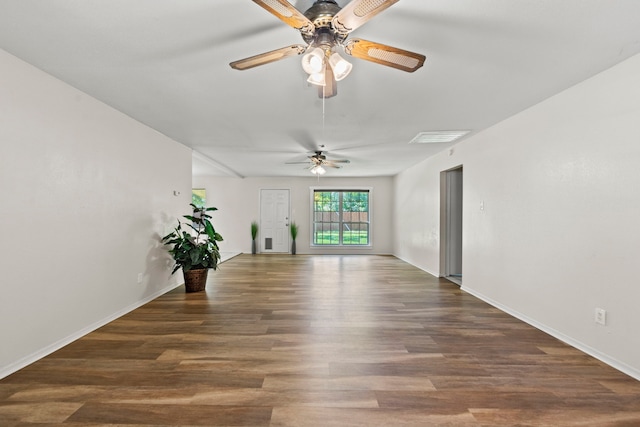 interior space with baseboards, a ceiling fan, and wood finished floors