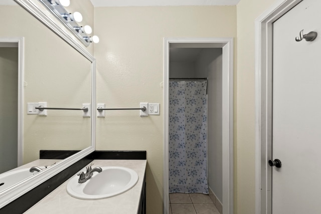 bathroom with tile patterned flooring, vanity, and curtained shower