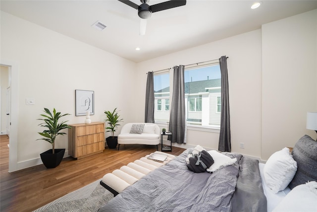 bedroom featuring ceiling fan, visible vents, recessed lighting, wood finished floors, and baseboards