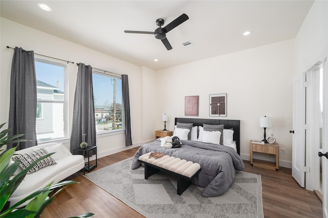 bedroom featuring visible vents, baseboards, recessed lighting, and wood finished floors