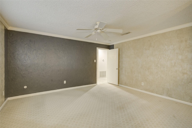 spare room featuring baseboards, a ceiling fan, carpet, and visible vents