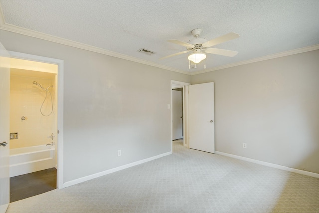 unfurnished bedroom with baseboards, ornamental molding, carpet, and visible vents