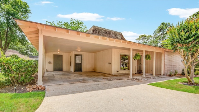 45 Champions Colony E, Houston, TX 77069 - view of front of property featuring mansard roof, a carport, and concrete driveway