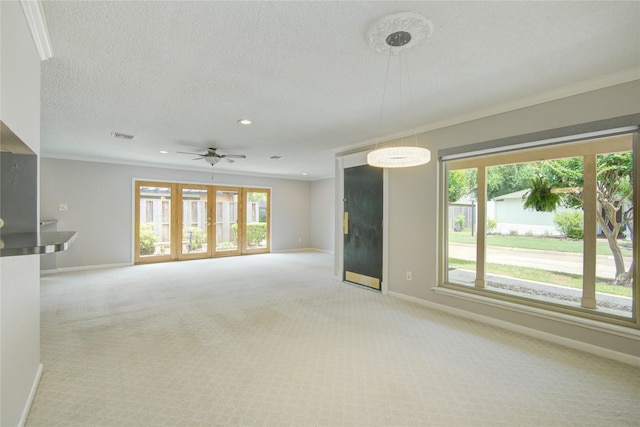 unfurnished living room with baseboards, light colored carpet, ornamental molding, and plenty of natural light