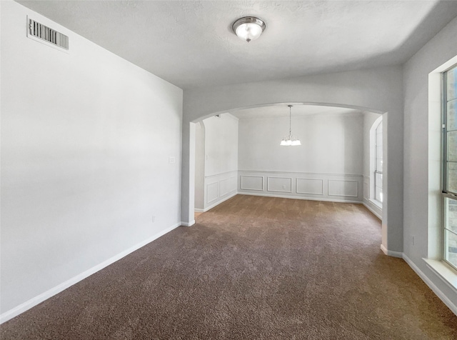 7206 Fiesta Flower, Katy, TX 77494 - empty room featuring arched walkways, visible vents, a notable chandelier, and carpet