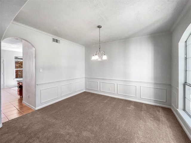 7206 Fiesta Flower, Katy, TX 77494 - carpeted empty room with visible vents, arched walkways, a decorative wall, ornamental molding, and a textured ceiling