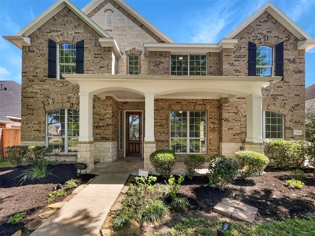 7206 Fiesta Flower, Katy, TX 77494 - view of front facade with brick siding, a porch, and stone siding
