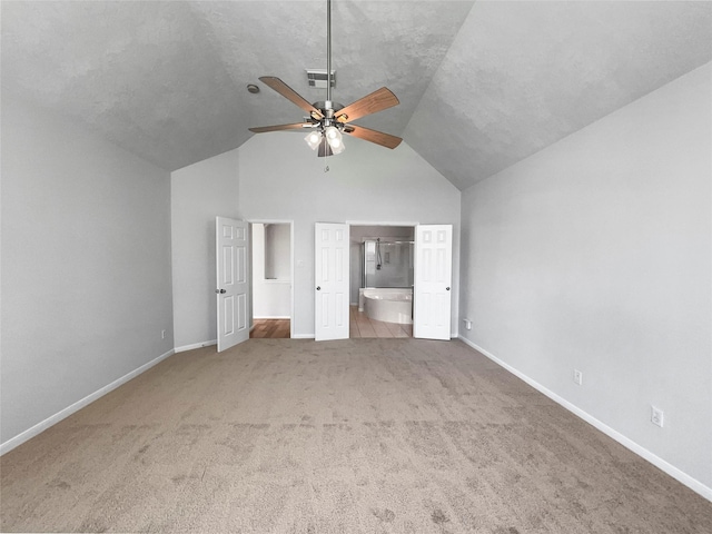 7206 Fiesta Flower, Katy, TX 77494 - unfurnished bedroom with visible vents, baseboards, carpet, and lofted ceiling