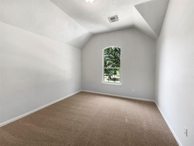 7206 Fiesta Flower, Katy, TX 77494 - additional living space featuring visible vents, baseboards, lofted ceiling, and carpet