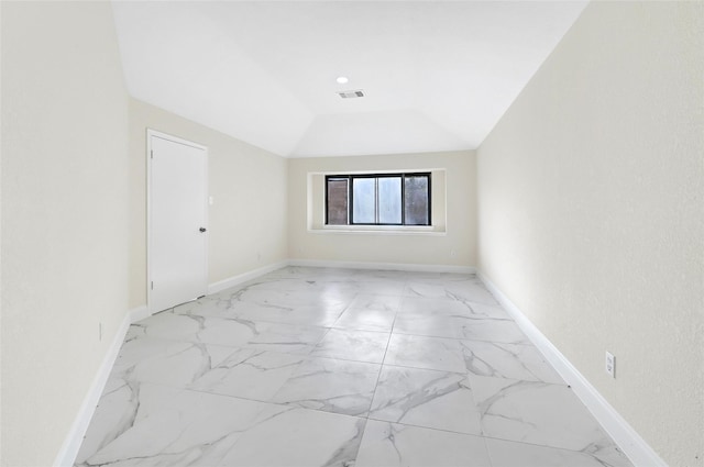 13723 Rocky Bluff Dr, Houston, TX 77085 - spare room featuring light marble finish flooring and vaulted ceiling