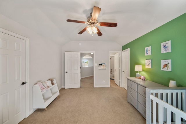 bedroom with lofted ceiling, light colored carpet, baseboards, and ceiling fan