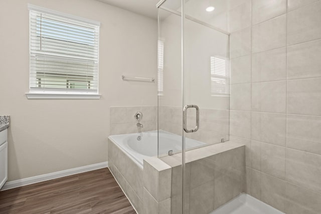 302 Elk Run Ln, Huntsville, TX 77320 - full bath with a shower stall, a garden tub, baseboards, wood finished floors, and vanity