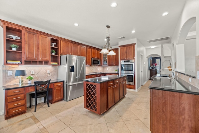 kitchen featuring open shelves, arched walkways, a sink, dark countertops, and appliances with stainless steel finishes