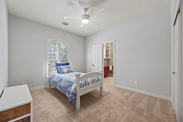 bedroom with visible vents, light colored carpet, and baseboards