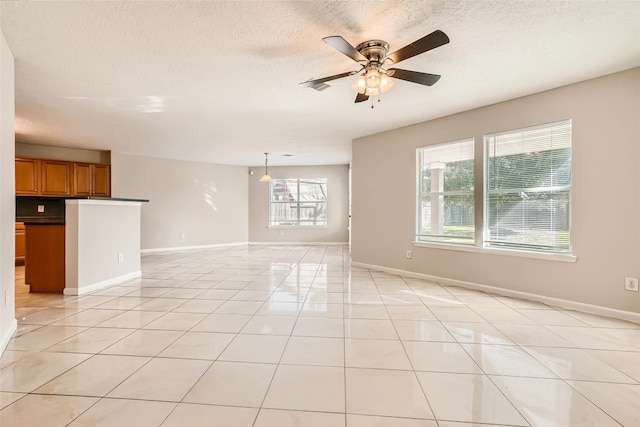 514 Remington Green Ct, Houston, TX 77073 - unfurnished living room featuring ceiling fan, a textured ceiling, baseboards, and light tile patterned flooring