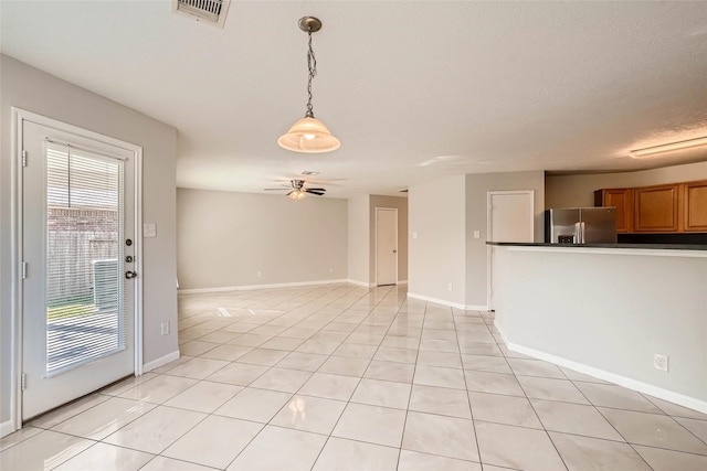 514 Remington Green Ct, Houston, TX 77073 - unfurnished living room featuring visible vents, baseboards, a ceiling fan, and light tile patterned floors