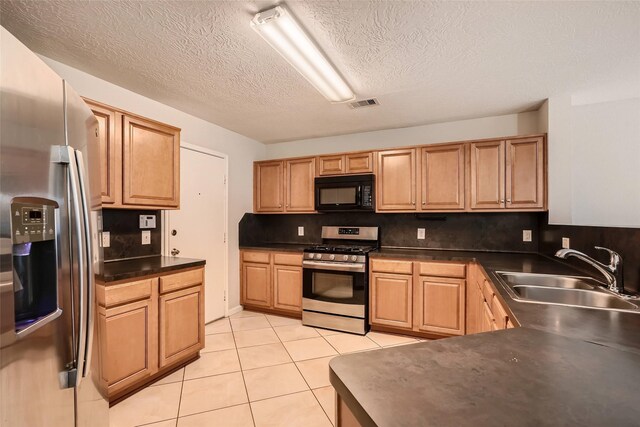 514 Remington Green Ct, Houston, TX 77073 - kitchen featuring visible vents, light tile patterned floors, a sink, appliances with stainless steel finishes, and dark countertops