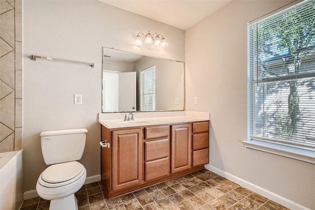 514 Remington Green Ct, Houston, TX 77073 - bathroom with toilet, a bath, vanity, and baseboards