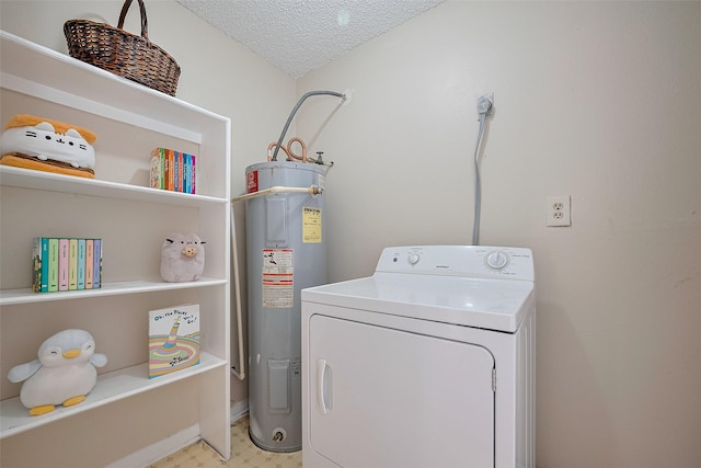laundry area featuring a textured ceiling, water heater, laundry area, and washer / dryer