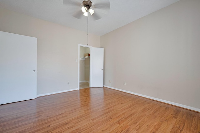 unfurnished room featuring baseboards, light wood-type flooring, and ceiling fan
