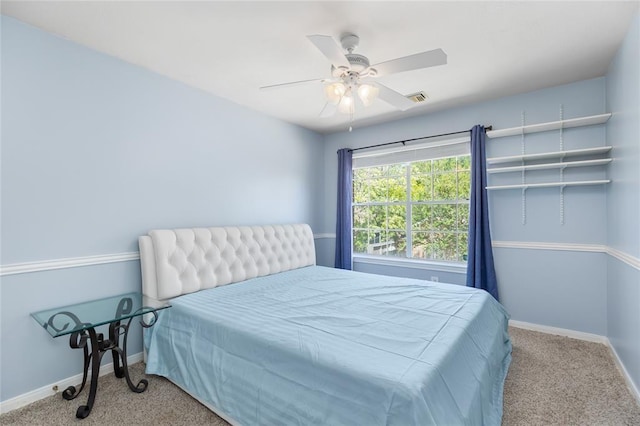 bedroom with visible vents, baseboards, a ceiling fan, and carpet floors