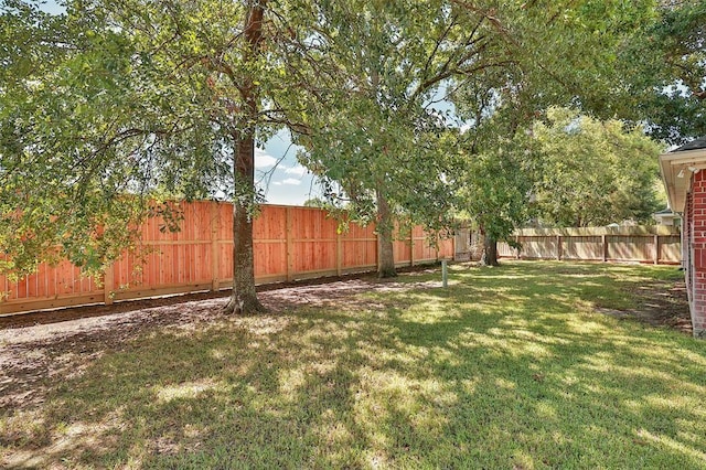 view of yard with a fenced backyard