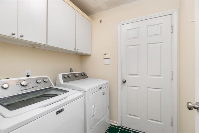 washroom featuring washing machine and dryer and cabinet space