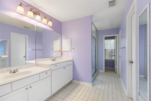 full bathroom featuring a shower stall, vanity, visible vents, and baseboards