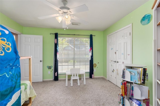 carpeted bedroom featuring visible vents, baseboards, and a ceiling fan