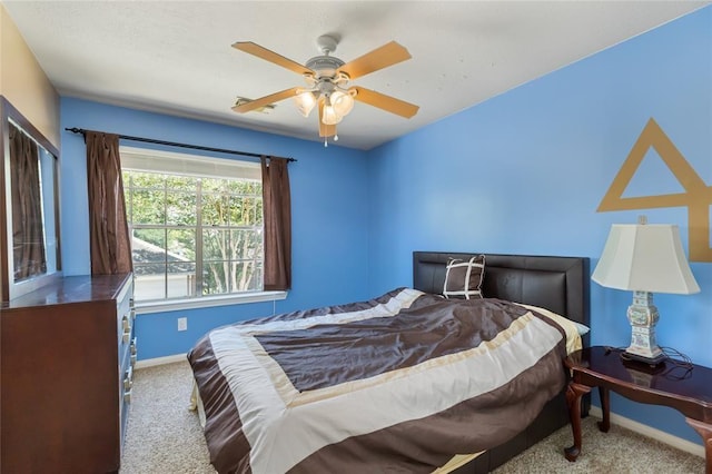 bedroom with carpet flooring, baseboards, and ceiling fan