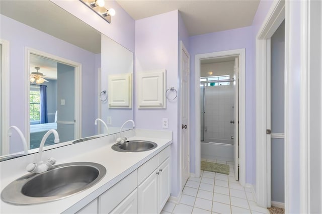 bathroom featuring a sink, baseboards, double vanity, and tile patterned flooring
