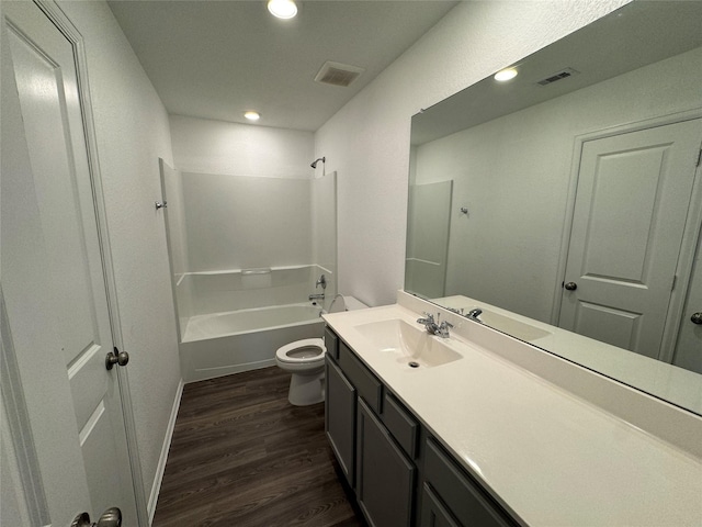 bathroom with wood finished floors, visible vents, shower / bath combination, toilet, and vanity
