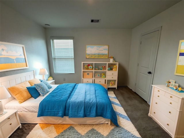 bedroom featuring dark colored carpet and visible vents