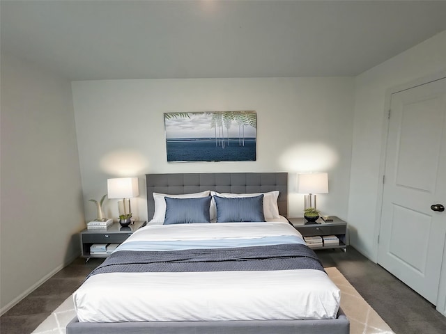 bedroom with baseboards and carpet
