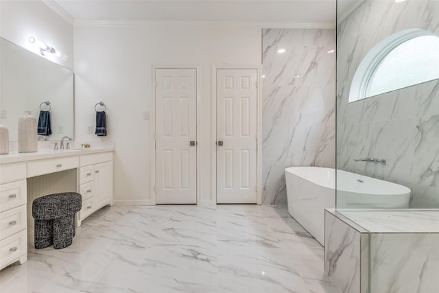 bathroom with ornamental molding, a freestanding tub, vanity, and marble finish floor