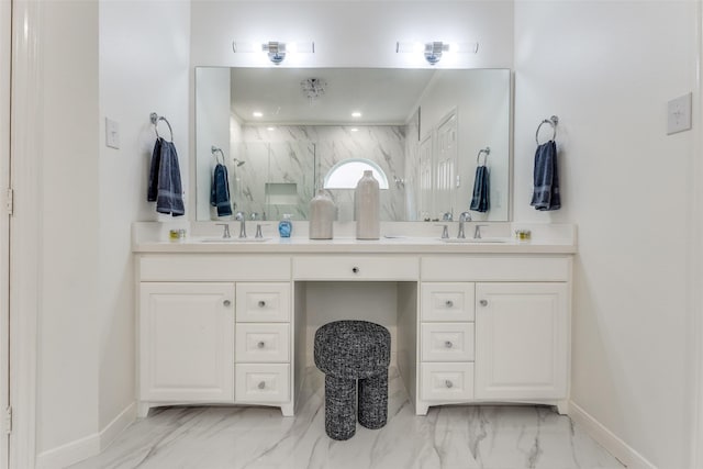 bathroom with double vanity, marble finish floor, a sink, and a marble finish shower