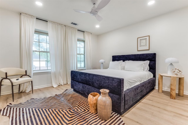 bedroom featuring wood finished floors, baseboards, visible vents, and recessed lighting